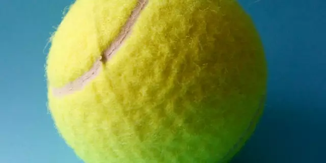 How do you put spin on a tennis ball?